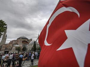 A man waves a Turkish national flag at the square of Hagia Sophia during the fourth anniversary of the failed coup attempt in Istanbul on July 15, 2020. Ozan KOSE / AFP