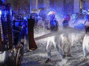 Israeli police spray protesters (clad in masks due to the COVID-19 coronavirus pandemic) with water cannon during a rally against Prime Minister Benjamin Netanyahu in Jerusalem, on July 19, 2020. Israeli police fired water cannons to disperse anti-government protests attended by thousands on Saturday, as public anger mounts over the handling of the coronavirus crisis. Demonstrators gathered outside Prime Minister Benjamin Netanyahu's residence in Jerusalem and at a park in Tel Aviv, voicing frustration over