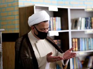 An Iranian cleric prays at a mosque in the capital Tehran, amid the ongoing novel coronavirus pandemic crisis, on July 19, 2020. Iran's president said yesterday that 35 million Iranians may contract the coronavirus, as the country still did not have herd immunity although a quarter of the population may have already been infected. The country has been battling a resurgence of COVID-19, with figures showing a rise in both new infections and deaths since a two-month low in May. ATTA KENARE / AFP