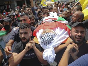 Palestinians carry the body of the local Fatah movement commander Imad Eddin Dweikat, who died in an altercation with Palestinian security forces last week, during his funeral in Balatah al-Balad, a suburb the city of Nablus in the Israeli-occupied West Bank, on July 27, 2020. JAAFAR ASHTIYEH / AFP