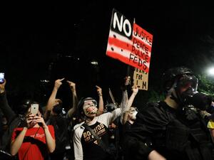 People gather in protest in front of the Mark O. Hatfield federal courthouse in downtown Portland as the city experiences another night of unrest on July 26, 2020 in Portland, Oregon. SPENCER PLATT / GETTY IMAGES NORTH AMERICA / Getty Images via AFP