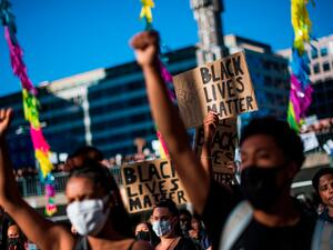 Protesters raise their fists during a Black Lives Matter demonstration in Stockholm, Sweden, June 3, 2020. (AFP)