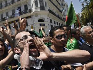 Algerian protesters shout anti-system slogans during the weekly Friday demonstration in the capital Algiers on June 21, 2019. (AFP)