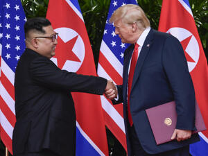 North Korea leader Kim Jong Un and U.S. President Donald Trump shaking hands in Singapore in June 2018 | Susan Walsh/AFP via Getty Images