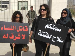 Palestinian women holding placards that read in Arabic, “There is no honour in killing women” (R), and “Your silence is a weapon for their killing”, in a protest against honour killing in the West Bank city of Ramallah, on March 6, 2014. Photo: ABBAS MOMANI / AFP
