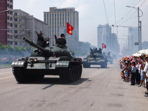 Military tanks parade in front of waving crowds through the streets of Pyongyang, North Korea. (Shutterstock/ File Photo)