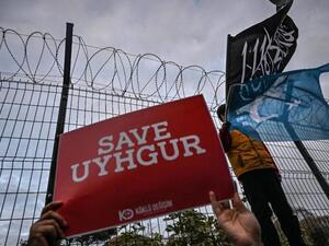 Protesters call on the international community to aid China’s Uighur Muslims outside the Chinese consulate in Istanbul on 13 December (AFP)