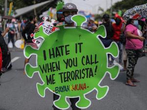 A protester carries a placard during a march towards the state university grounds for a rally in Manila on July 27, 2020, ahead of Philippine President Rodrigo Duterte's annual State of the Nation Address in congress. Maria TAN / AFP