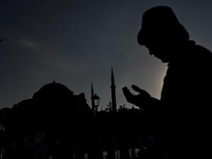 A man wearing a fez prays during the Eid al-Adha prayers outside Hagia Sophia in Istanbul on July 31, 2020. Muslims are celebrating Eid al-Adha or feast of sacrifice, the second of two Islamic holidays celebrated worldwide marking the end of the annual pilgrimage or Hajj to the Saudi holy city of Mecca. Ozan KOSE / AFP