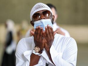 A Muslim pilgrim, clad in a face mask due to the COVID-19 coronavirus pandemic, prays after throwing pebbles as part of the symbolic al-A'qabah (stoning of the devil ritual) at the Jamarat Bridge during the Hajj pilgrimage in Mina, near Saudi Arabia's holy city of Mecca, on August 2, 2020. Massive crowds in previous years triggered deadly stampedes during the ritual, but this year only up to 10,000 Muslims are taking part after millions of international pilgrims were barred because of the covid-19 pandemic 