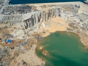 An aerial view taken on August 9, 2020, shows a general view of the port of Beirut, the damaged grain silo and the crater caused by the colossal explosion of a huge pile of ammonium nitrate that had languished for years in a port warehouse, leaving scores of people dead or injured and causing devastation in the Lebanese capital. The huge chemical explosion that hit Beirut's port, devastating large parts of the Lebanese capital and claiming over 150 lives, left a 43-metre (141 foot) deep crater, a security o