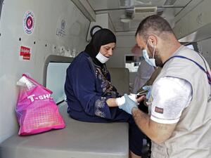 Medics working at a mobile clinic held jointly by Lebanese NGO Amel Association International and Medecins du Monde (MDM) provide medical care on August 11, 2020 to the residents of Beirut's badly-damaged Karantina district following the earth-shaking explosion which killed more than 170 people and wounded more than 6,000 in the Lebanese capital on August 4. Volunteers of Amel Association International, a local charity founded during the 1975-1990 civil war, and MDM or Doctors of the World, an international