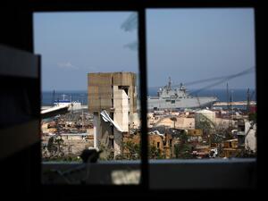 The French Navy amphibious assault helicopter carrier Tonnerre, docked at the Beirut port, is pictured from a damaged apartment in the neighbourhood of Mar Mikhael on August 14, 2020, more than a week after a massive blast ravaged the port and parts of the Lebanese capital. The catastrophic Beirut explosion on August 4 killed 171 people, injured thousands and laid waste to whole neighbourhoods. PATRICK BAZ / AFP