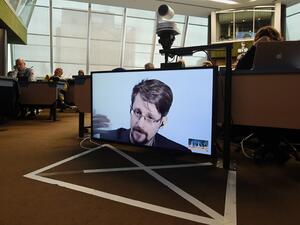In this file photo former US National Security Agency (NSA) contractor and whistle blower Edward Snowden speaks via video link from Russia as he takes part in a round table meeting on the subject of "Improving the protection of whistleblowers" on March 15, 2019, at the Council of Europe in Strasbourg, eastern France. President Donald Trump said August 15 he will "take a look" at pardoning Edward Snowden, the former US intelligence contractor who revealed in 2013 that the US government was spying on its citi