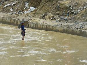 A Rohingya refugee stands in the waters of a canal at Kutupalong refugee camp near Ukhia on August 25, 2020. Almost a million Rohingya refugees stuck in Bangladesh marked three years since escaping from Myanmar on August 25, with coronavirus forcing them to hold a day-long "silent protest" inside their flimsy, leaky huts. Munir Uz zaman / AFP