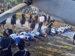 The grainy photograph that appeared on social media showed a man in a white shirt and grey trousers stepping on the backs of about 30 people lined up on the ground. (Twitter)