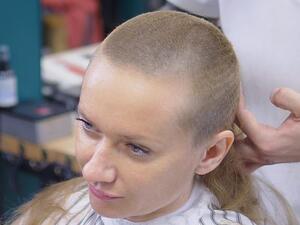 A file photo shows a woman having her long hair shaved off. The parents, uncle and aunt of a teenager of Bosnian Muslim origin will face trial in France on charges of violence against a minor for shaving her head because of her relationship with a Christian Serbian boy  (Shutterstock)