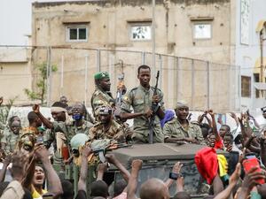 Armed members of the FAMA (Malian Armed Forces) are celebrated by the population as they parade at Independence Square in Bamako, Mali on Wednesday. Photo: AFP