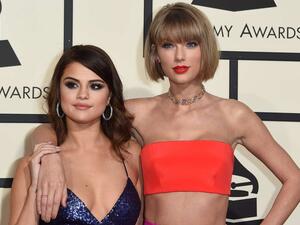 Singer Taylor Swift (R) and Selena Gomez arrive on the red carpet for the 58th Annual Grammy music Awards in Los Angeles February 15, 2016. AFP PHOTO/ VALERIE MACONVALERIE MACON/AFP/Getty Images