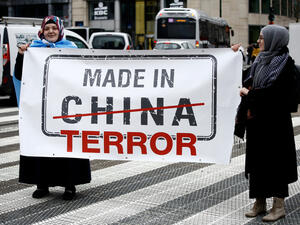 Activists protest the treatment of Uyghur Muslims by Chinese authorities in Xinjiang province at a protest outside the headquarters of the European Union. (Shutterstock/ File Photo)