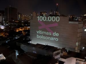 A projection on a building honouring the 100,000 victims who died of the novel coronavirus COVID-19 in Brazil reads "100,000 Victims of (Brazilian President Jair) Bolsonaro" as the country became the second in the world to pass the grim milestone, in Botafogo neighbourhood in Rio de Janeiro, Brazil, on August 8, 2020. Mauro PIMENTEL / AFP