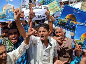 Demonstrators chant slogans with signs depicting Jerusalem's Dome of the Rock alongside other signs reading in Arabic "no to normalisation with the Zionist entity", during a protest in Yemen's third city of Taez on August 21, 2020. AHMAD AL-BASHA / AFP