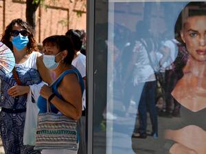 Teachers and nonacademic personnel queue to undergo PCR tests outside the Virgen de la Paloma high school, ahead of the reopening of schools for a new academic year amid the coronavirus pandemic, in Madrid on September 2, 2020. Gabriel BOUYS / AFP