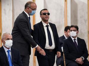 Tunisia's Culture Minister Walid Zidi (who is blind) is assisted to take the oath of office during the new government swearing-in ceremony at Carthage Palace on the eastern outskirts of the capital Tunis on September 2, 2020, following a confidence vote by parliament. FETHI BELAID / AFP