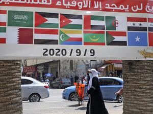 A banner showing the flags of Arab countries and reading "History will only glorify those loyal to Palestine" is seen during a rally against the UAE-Israel normalisation deal in the occupied West Bank city of Nablus on September 9, 2020, as Arab foreign ministers meet. JAAFAR ASHTIYEH / AFP