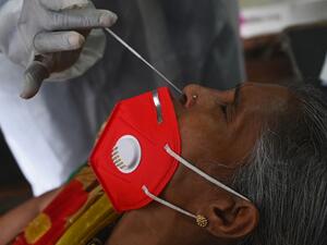 A health worker conducts a nasal swab during a Covid-19 coronavirus screening for frontline civic staff in Mumbai on September 10, 2020. INDRANIL MUKHERJEE / AFP