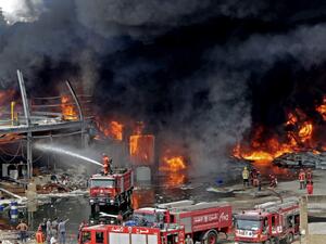 Lebanese firefighters try to put out a fire that broke out at Beirut's port area, on September 10, 2020. Thick black columns of smoke rose into the sky, as the army said it had engulfed a warehouse storing engine oil and vehicle tyres.  ANWAR AMRO / AFP
