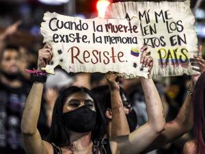 A woman holds a sign reading “When death exists, memory resists” during a protest against police brutality in Medellin, Colombia, on September 14, 2020. (AFP)