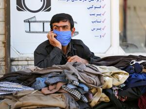 An Iranian Kurdish vendor speaks on the phone as he waits for customers in the town of Sardasht in Iran's West Azerbaijan Province on September 14, 2020. ATTA KENARE / AFP
