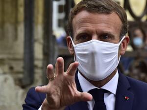French President Emmanuel Macron, wearing a protective face mask, speaks to the journalists during a visit at the Polignac castle on September 18, 2020 in Condom, on the eve of the European Heritage Days and the third edition of the "Loto du Patrimoine" lottery draw aiming at help restoring heritage sites at risk. GEORGES GOBET / AFP / POOL