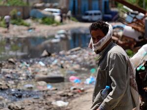 A manstands along a street flooded with open sewers and covered with rubbish in Yemen's third city of Taez, on September 19, 2020. Human Rights Watch warned of "deadly consequences" as a result of the obstruction of aid in war-torn Yemen, where the humanitarian effort has already been badly hit by the coronavirus crisis. Interviews with 35 humanitarian workers, 10 donor officials and 10 Yemeni health workers revealed a complex web of restrictions that hinder the flow of aid. AHMAD AL-BASHA / AFP