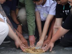 In this file photo taken on September 20, 2020, pro-democracy protest leaders unveil a plaque on Sanam Luang field in Bangkok, following an overnight anti-government demonstration. A plaque installed by activists in Bangkok declaring Thailand "belongs to the people" had been removed on September 21, after a weekend show of force by protesters calling for the royal family to stay out of the kingdom's politics. Vivek PRAKASH / AFP