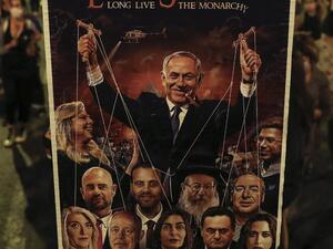 An Israeli protester holds a sign depicting Prime Minister Benjamin Netanyahu as running a string of right-leaning politicians beneath him while his wife Sara laughs, during an anti-government demonstration outside his residence in Jerusalem, on September 20, 2020. Ahmad GHARABLI / AFP