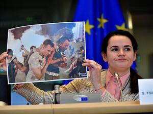 Belarus opposition leader Svetlana Tikhanovskaya holds up a photograph as she addresses members of the EU parliament at the EU headquarters in Brussels on September 21, 2020. European foreign ministers welcomed Belarus opposition leader Svetlana Tikhanovskaya to Brussels as they prepare EU sanctions to support her battle against the Minsk regime. The former Soviet republic has been convulsed by unprecedented demonstrations against President Alexander Lukashenko since he was returned to power in a disputed A