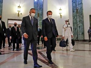 French President Emmanuel Macron (centre right), mask-clad due to the COVID-19 pandemic, arrives for a meeting with Iraq's Prime Minister Mustafa al-Kadhimi (centre left) in the capital Baghdad on September 2, 2020. (GONZALO FUENTES / POOL / AFP)