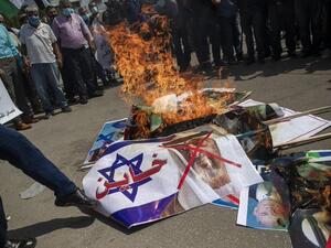 Palestinians burn pictures of U.S. President Trump, Israeli Prime Minister, Bahrain's King and Abu Dhabi Crown Prince during a protest against the United Arab Emirates and Bahraini normalization agreement with Israel, in Gaza City, September 15, 2020. (Twitter)