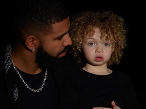 Adonis is photographed wearing a black hoodie with black sweatpants 