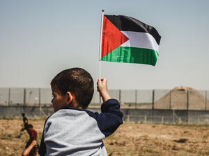 Small kid hold palestinian flag during the "Great March of Return" at the Israeil-Gaza border, on May15, 2019. (Shutterstock/ File Photo)