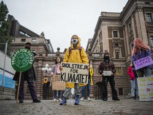 Swedish climate activist Greta Thunberg protests with her placard reading "School strike for climate" as part of her Fridays for Future protest in front of the Swedish Parliament Riksdagen in Stockholm on October 9, 2020. Jonathan NACKSTRAND / AFP