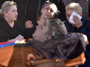 Relatives react by the coffin of soldier Vazgen Aslanyan, who was killed in the fighting between Armenia and Azerbaijan over the breakaway region of Nagorno-Karabakh, during a funeral ceremony at Yerablur military pantheon in Yerevan on October 10, 2020. Karen MINASYAN / AFP