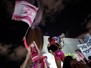 An Israeli protester addresses the crowd with a megaphone during a demonstration against Prime Minister Benjamin Netanyahu in the coastal city of Tel Aviv, on October 10, 2020. EMMANUEL DUNAND / AFP