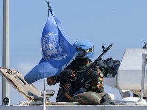 A United Nations peacekeeping force (UNIFIL) soldier examines a weapon as he sits atop a vehicle patrolling the Lebanese southern coastal area of Naqura by the border with Israel, on October 11, 2020. Mahmoud ZAYYAT / AFP