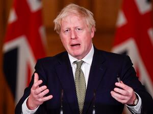 Britain's Prime Minister Boris Johnson gestures as he speaks during a virtual press conference inside 10 Downing Street in central London on October 12, 2020. (AFP/File)