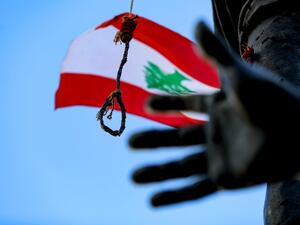 In this file photo taken on August 9, 2020, shows a noose and a gallows hanging from the Martyrs' Statue along with Lebanese national flags, at the Martyrs' Square in the centre of Lebanon's capital Beirut. JOSEPH EID / AFP