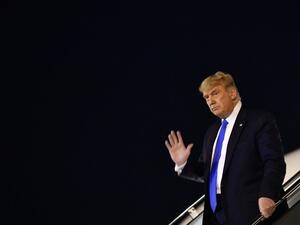 US President Donald Trump waves as he steps off Air Force One upon arrival at McCarran International Airport in Las Vegas, Nevada on October 18, 2020. MANDEL NGAN / AFP