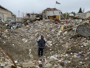A man stands among the debris of a destroyed house hit by a rocket strike during the ongoing military conflict between Armenia and Azerbaijan over the breakaway region of Nagorno-Karabakh, in a residential area of the city of Ganja, Azerbaijan, on October 21, 2020. TOFIK BABAYEV / AFP